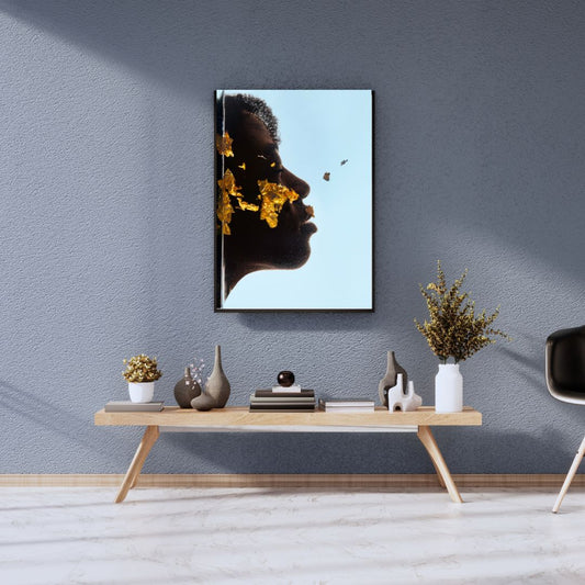 Framed artwork of a woman's face with flowers on a gray wall above a wooden console table.