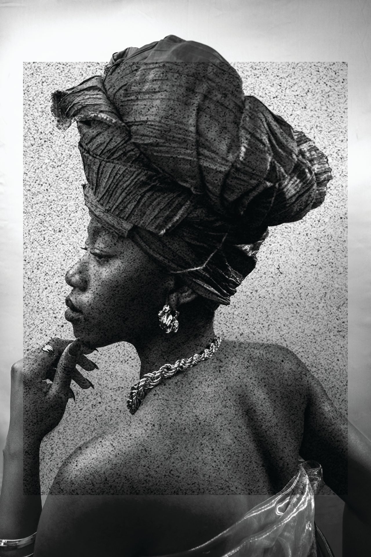 Black and white portrait of a woman wearing a traditional headwrap.